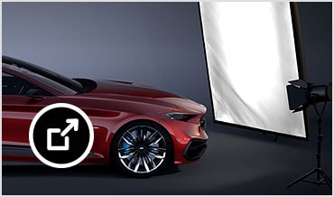 Sports car lit up by studio lights and a large reflector in VRED