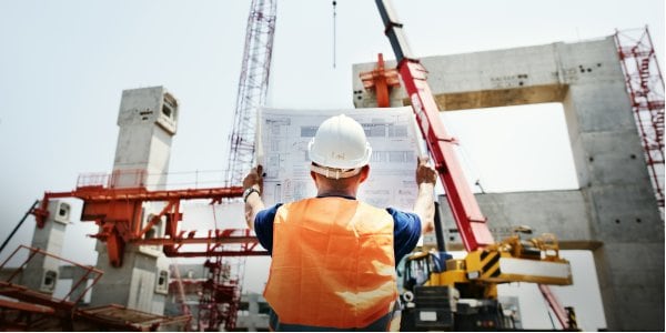 Construction worker reading a blueprint