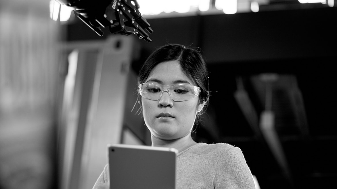 woman looking at CAD drawing on tablet