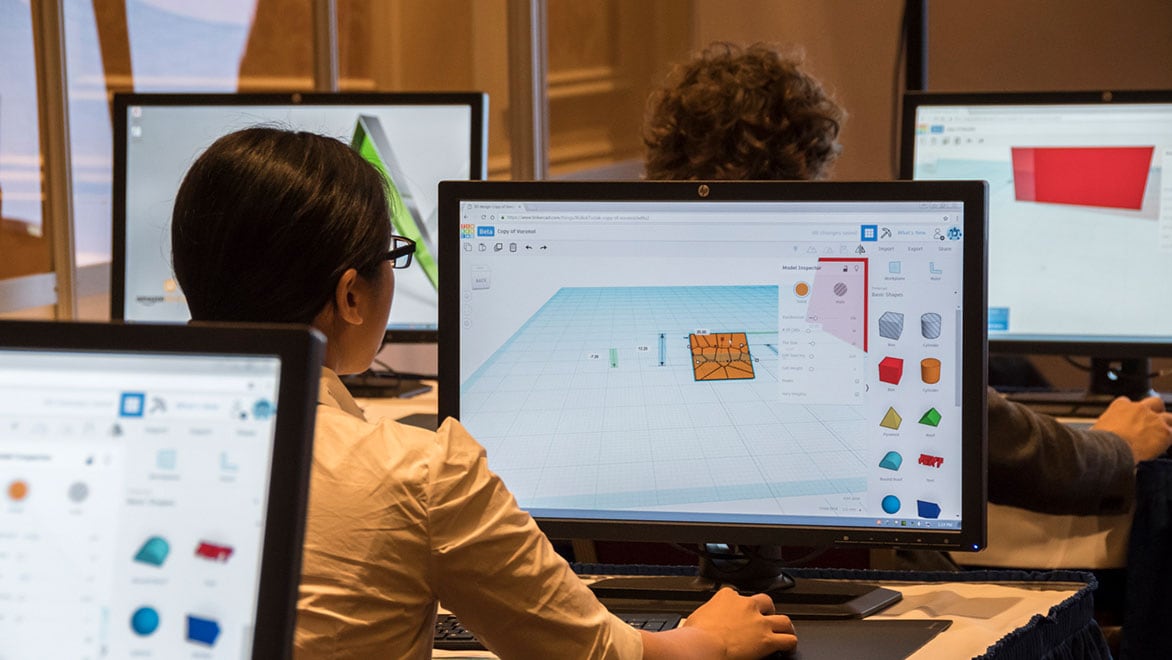 Woman using Tinkercad on computer.