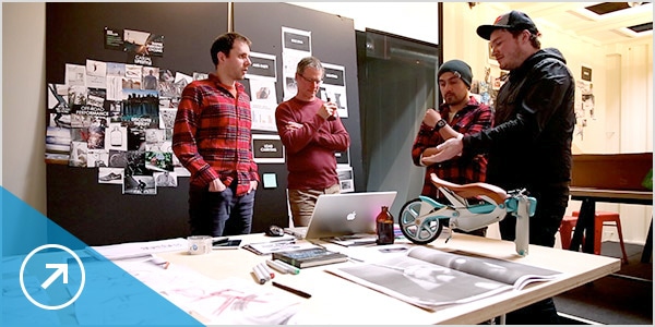 Team members collaborate on a bicycle design