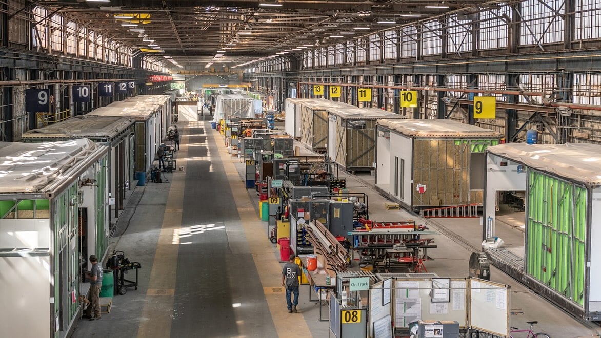 A large manufacturing facility in which construction modules are being assembled.