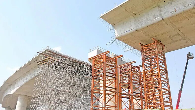 Illustration of owners and program managers discussing a project in an office setting, one reviewing a document while the other gestures toward a digital display, with charts and plans in the background.