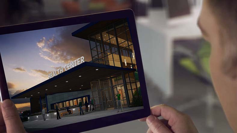 Man viewing a rendering of a health care center on a tablet