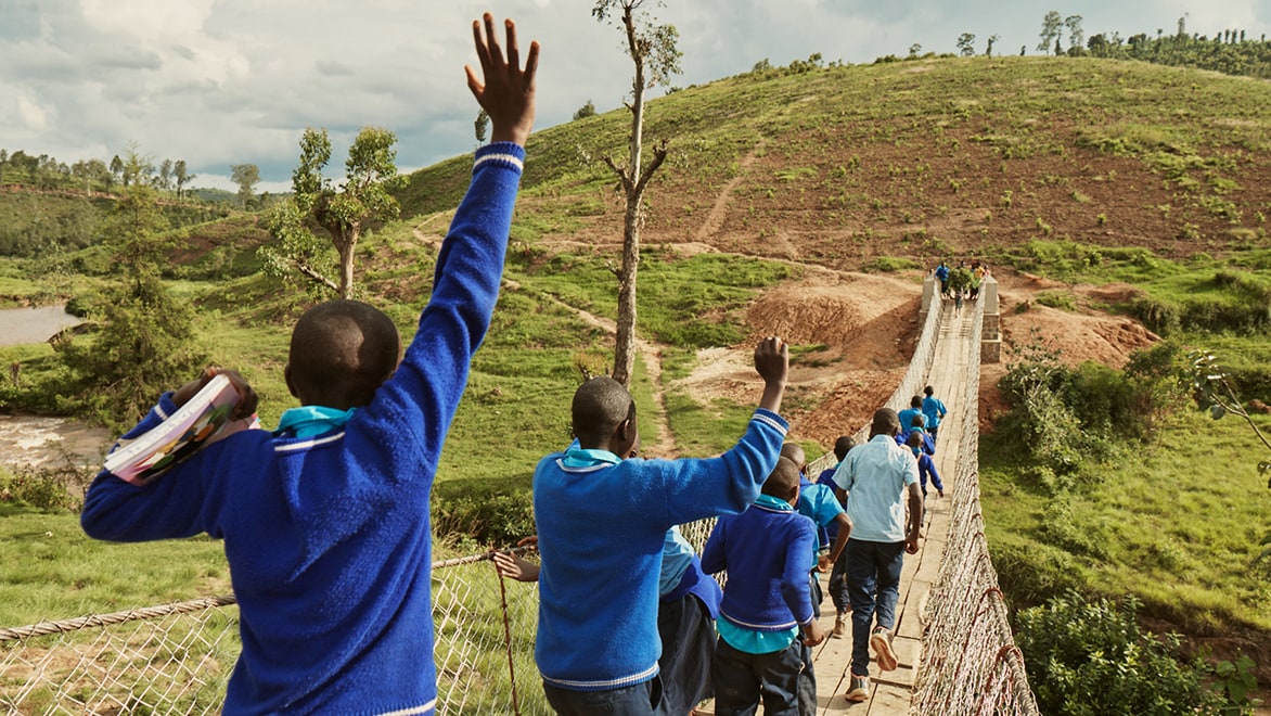 Kids cross a Bridges to Prosperity trail bridge in Rwanda