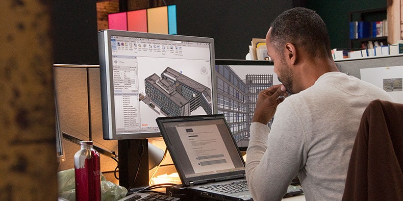 Man working with Revit on a computer