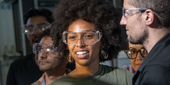 Smiling woman wearing safety glasses