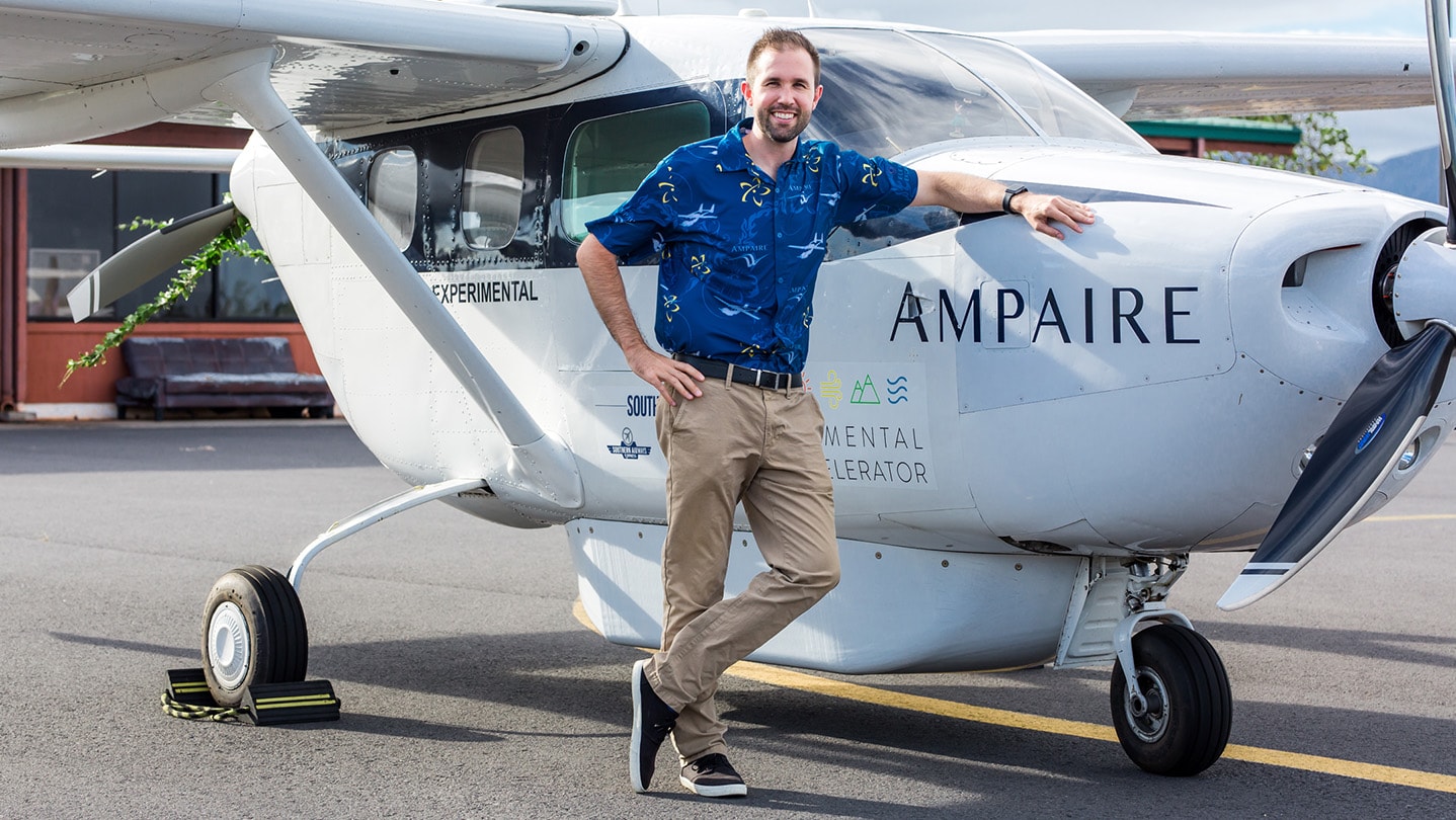 A man standing next to an Ampaire hybrid-electric aircraft