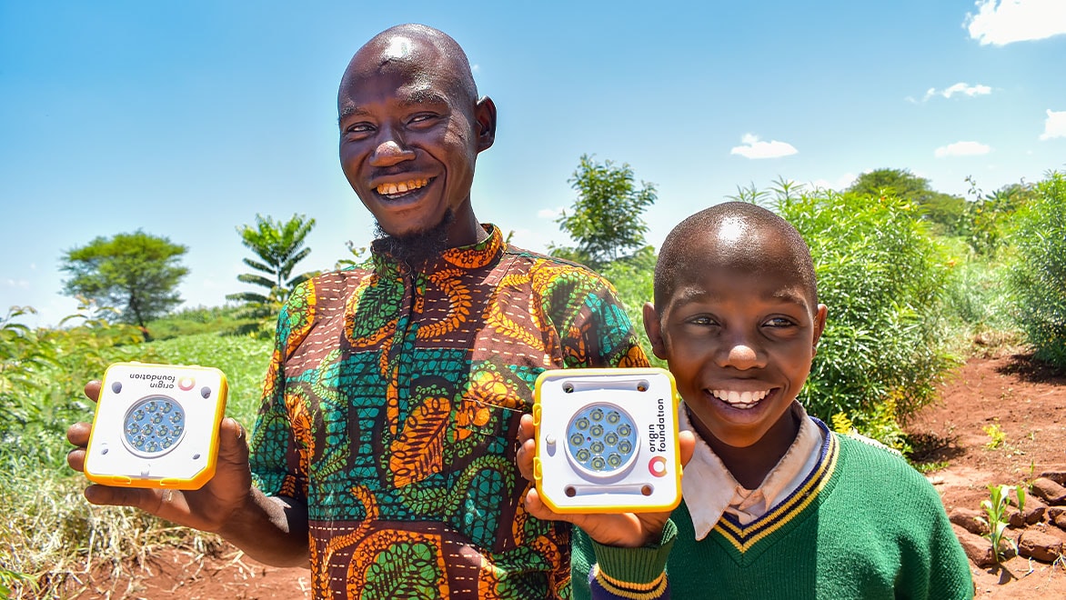 Two people holding solar powered technology