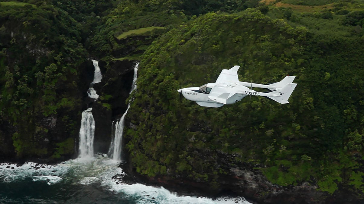 Electric aircraft flies over waterfalls