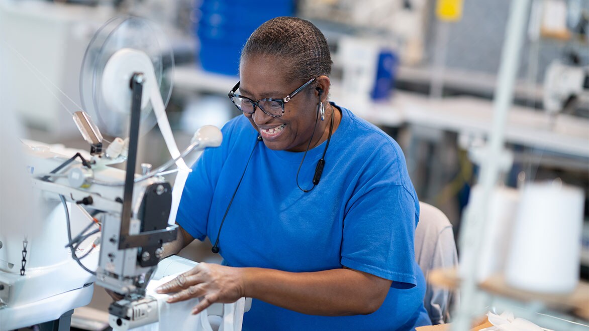 ISAIC employee sews personal protective equipment